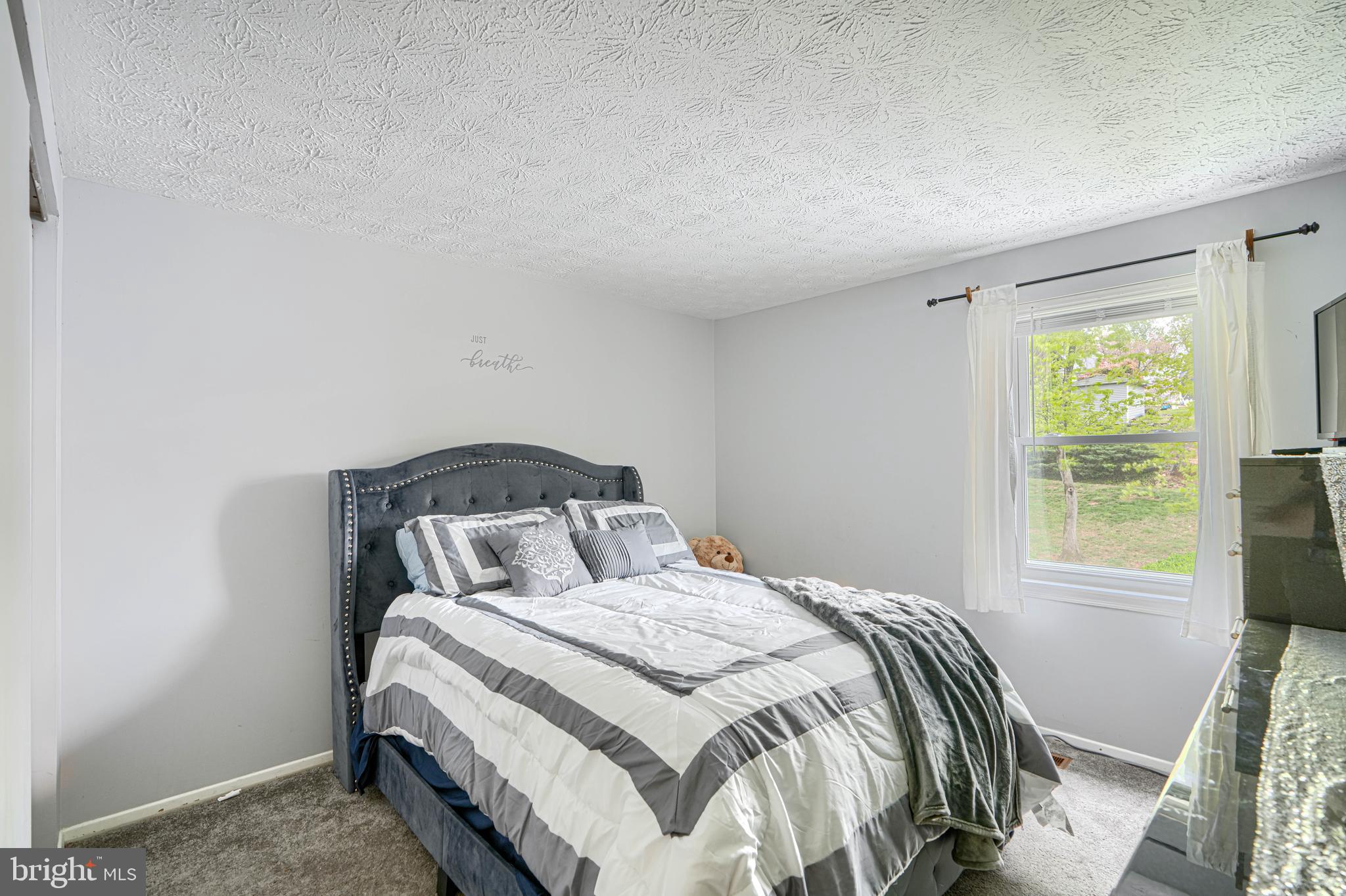 9405 Perglen Road Nottingham, MD 21236 - Photo 19 of 36 a bedroom with a bed and a window