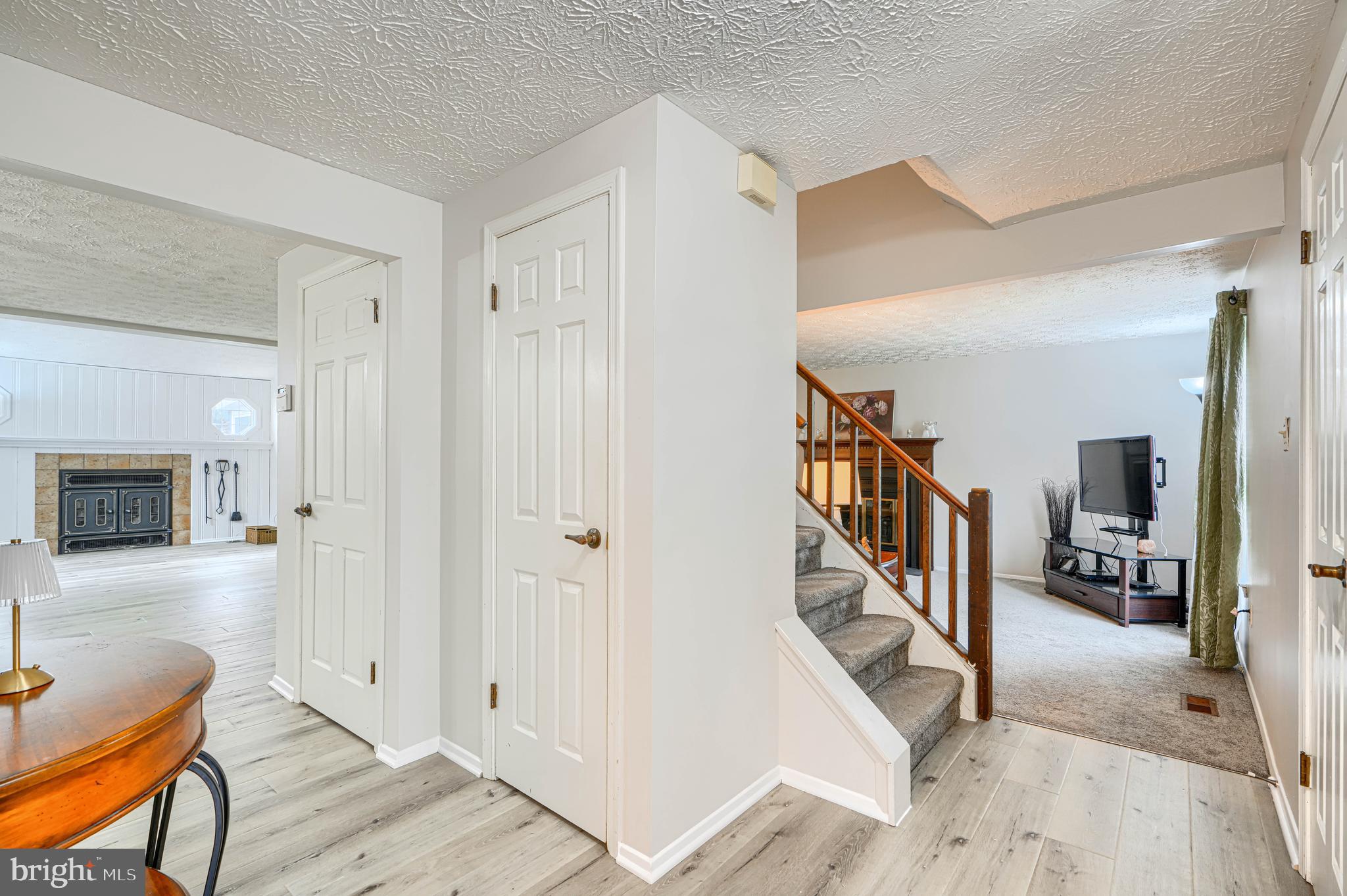 9405 Perglen Road Nottingham, MD 21236 - Photo 5 of 36 a view of a hallway with wooden floor and staircase
