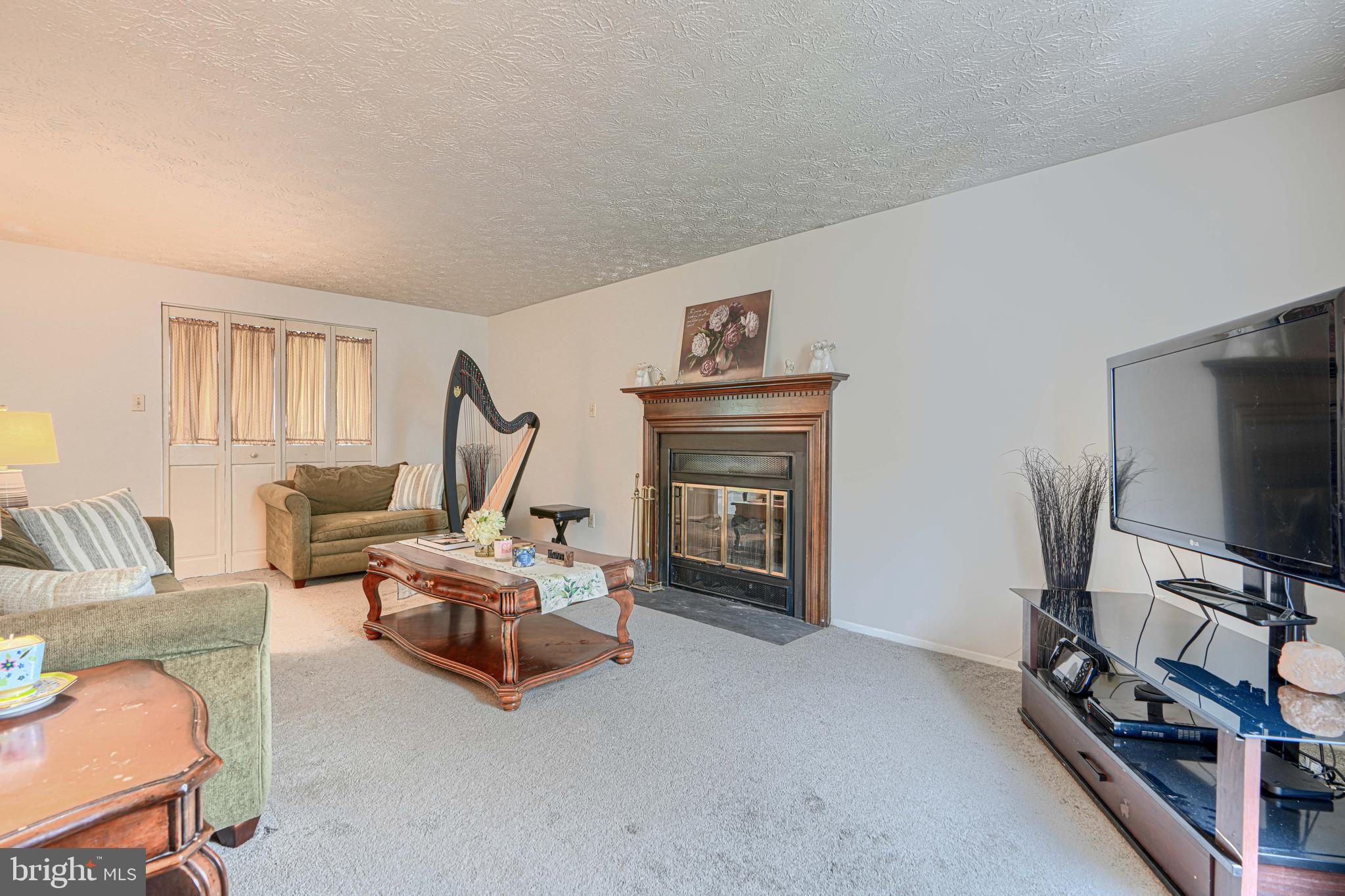 9405 Perglen Road Nottingham, MD 21236 - Photo 6 of 36 a living room with furniture and a flat screen tv
