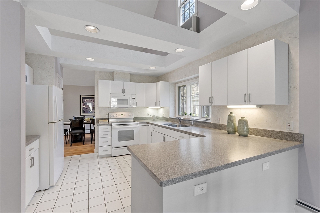 34 Pickman Drive, Unit 34 Bedford, MA 01730 - Photo 18 of 38 a kitchen with stainless steel appliances granite countertop a sink dishwasher stove top oven and refrigerator