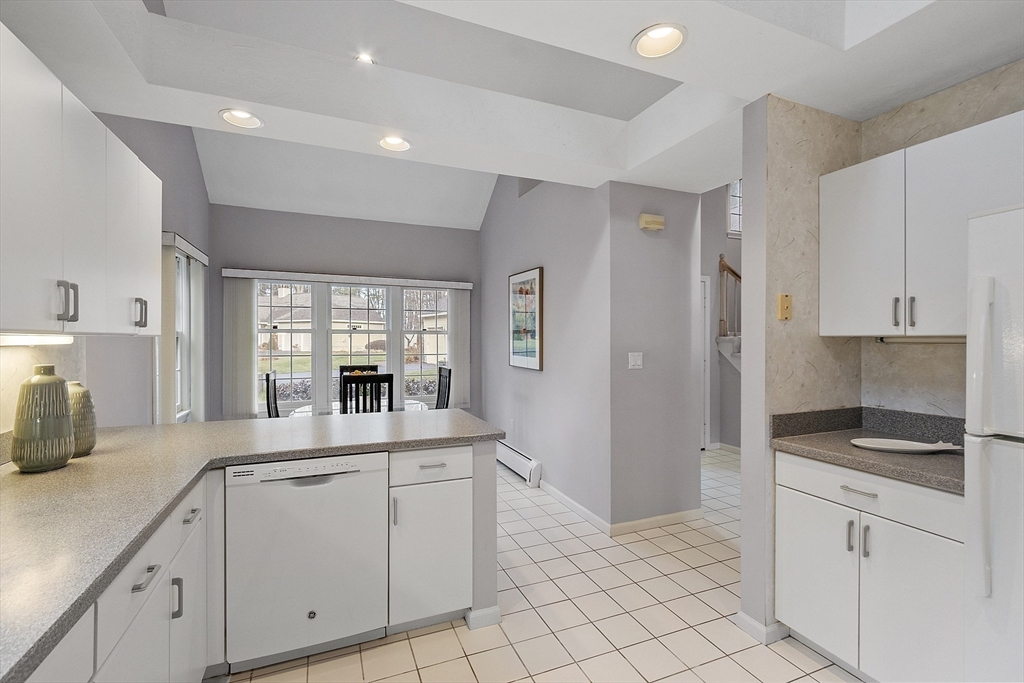 34 Pickman Drive, Unit 34 Bedford, MA 01730 - Photo 23 of 38 a kitchen with white cabinets and appliances