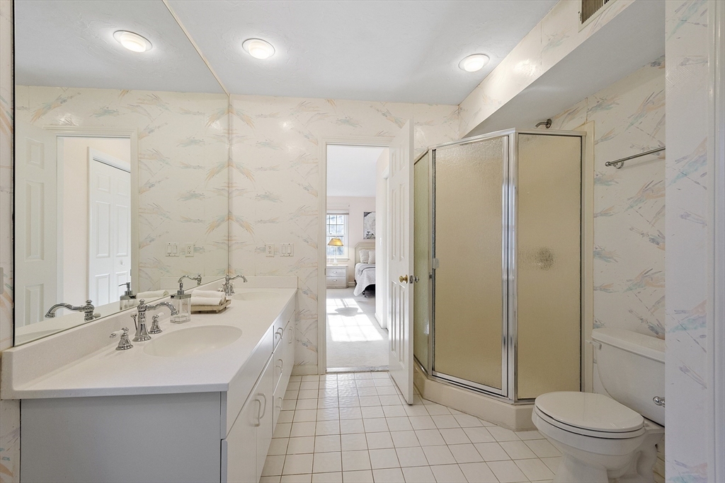 34 Pickman Drive, Unit 34 Bedford, MA 01730 - Photo 28 of 38 a bathroom with a double vanity sink toilet and shower
