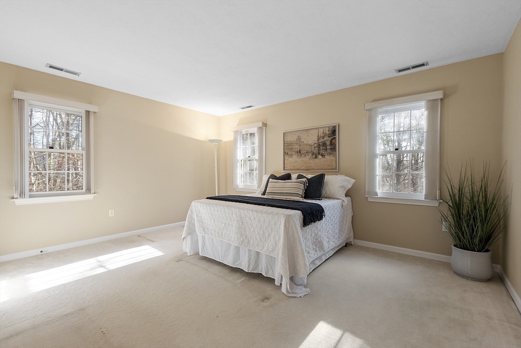 34 Pickman Drive, Unit 34 Bedford, MA 01730 - Photo 30 of 38 a spacious bedroom with a bed and a window