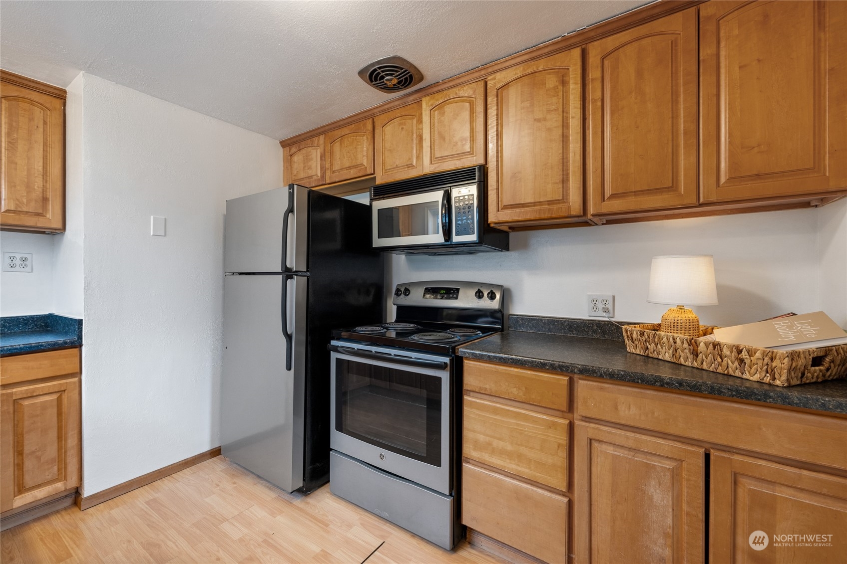 5037 South State Street Tacoma, WA 98409 - Photo 13 of 40 a kitchen with stainless steel appliances granite countertop a stove a refrigerator and a cabinets