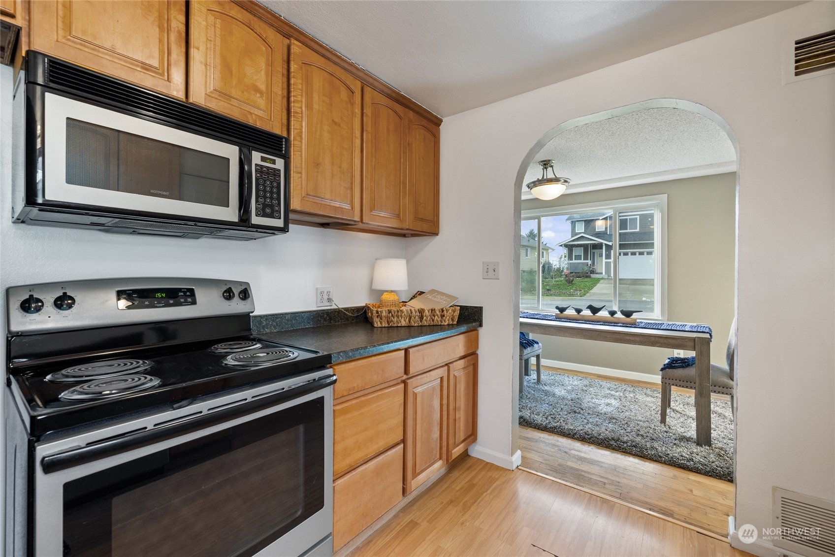 5037 South State Street Tacoma, WA 98409 - Photo 14 of 40 a kitchen with stainless steel appliances a stove microwave and sink