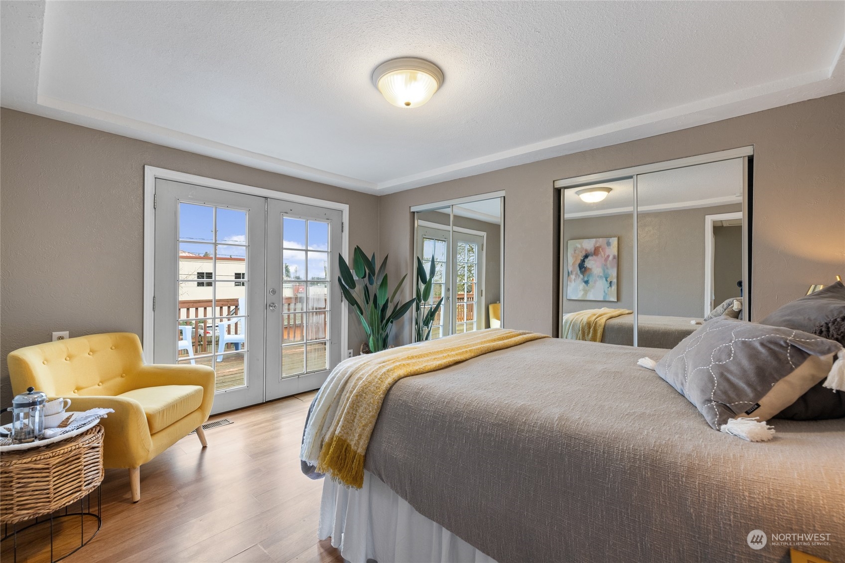 5037 South State Street Tacoma, WA 98409 - Photo 15 of 40 a bedroom with a bed and wooden floor