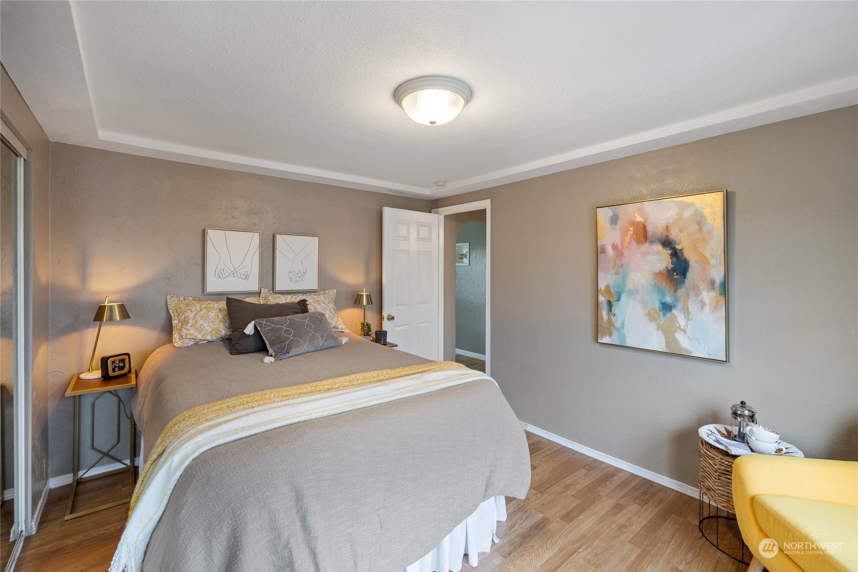 5037 South State Street Tacoma, WA 98409 - Photo 16 of 40 a bed room with a bed and a painting on the wall