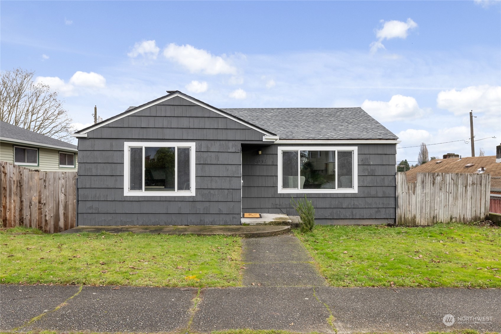 5037 South State Street Tacoma, WA 98409 - Photo 2 of 40 a front view of a house with a garden