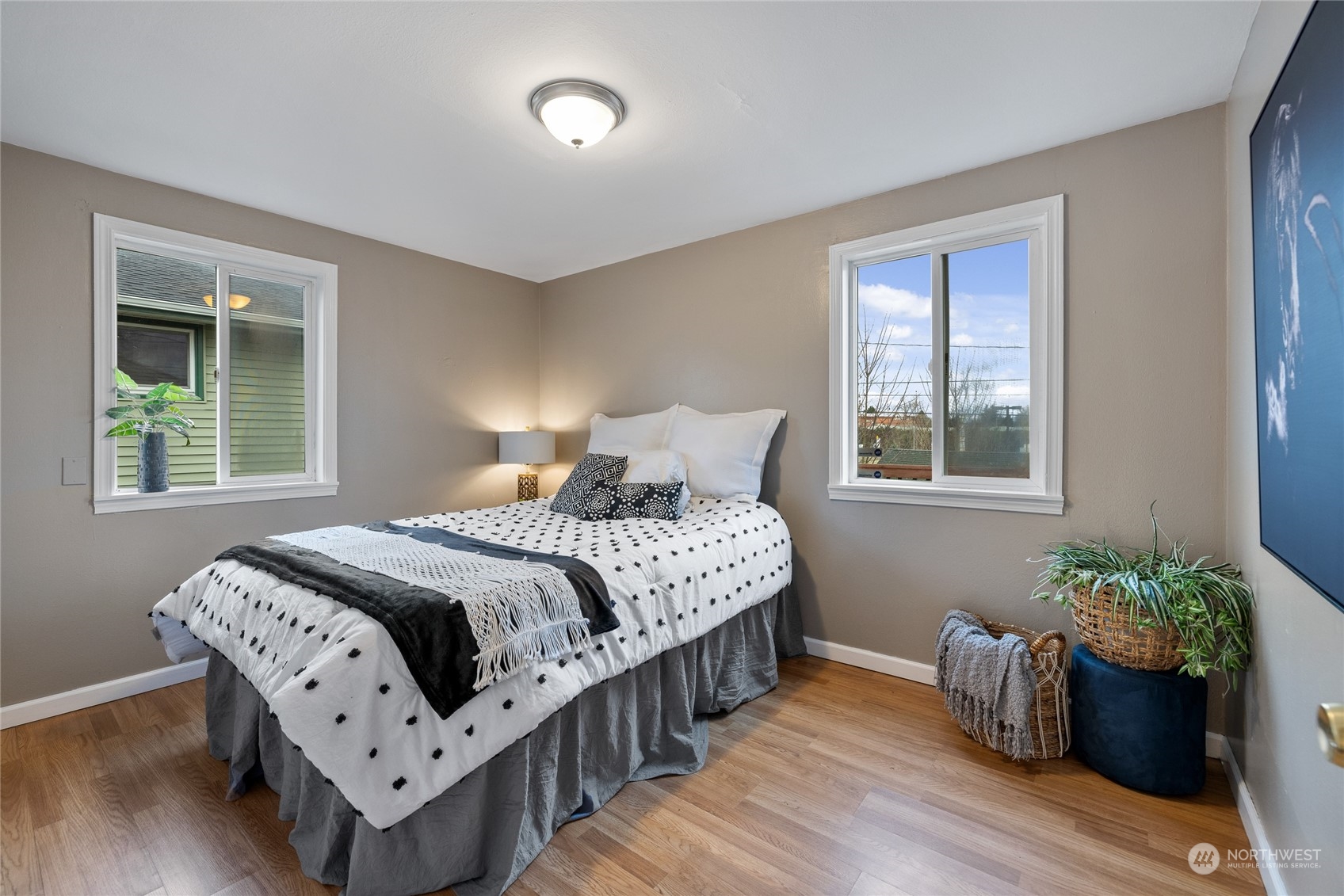 5037 South State Street Tacoma, WA 98409 - Photo 21 of 40 a bedroom with a bed and wooden floor