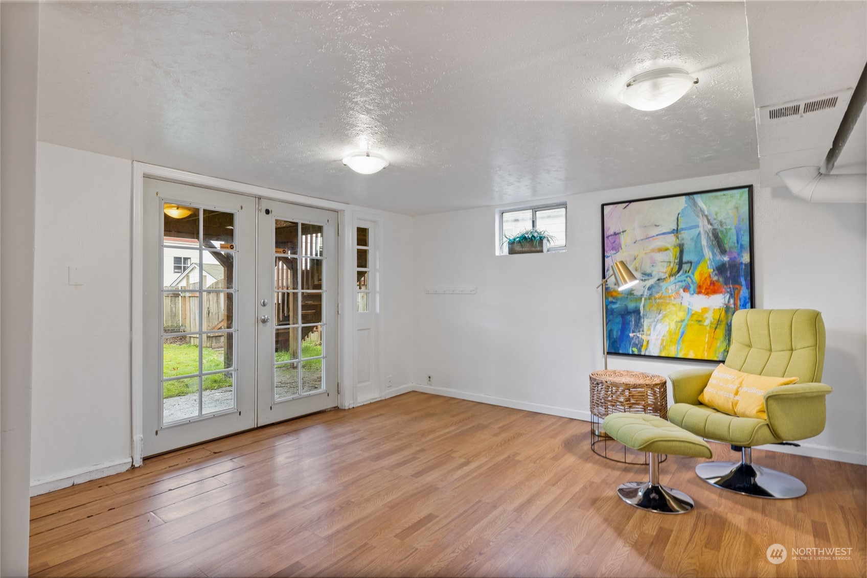 5037 South State Street Tacoma, WA 98409 - Photo 28 of 40 a workspace with furniture wooden floor a painting on the wall