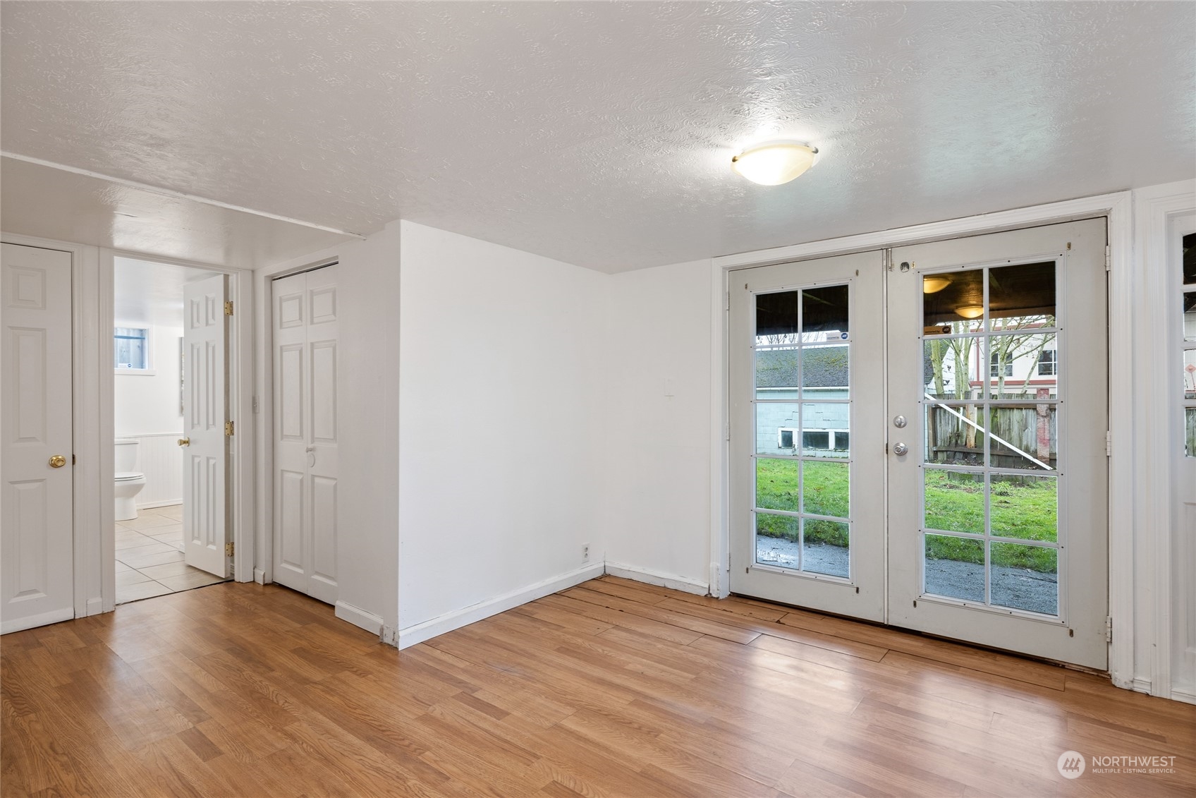 5037 South State Street Tacoma, WA 98409 - Photo 31 of 40 a view of empty room with wooden floor and fan