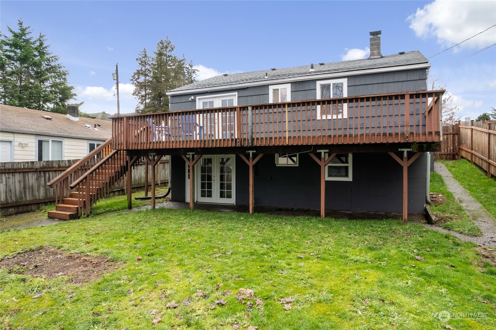 5037 South State Street Tacoma, WA 98409 - Photo 33 of 40 a view of a house with a yard and a wooden deck