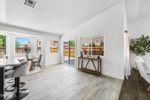 a view of a livingroom with furniture and hardwood floor