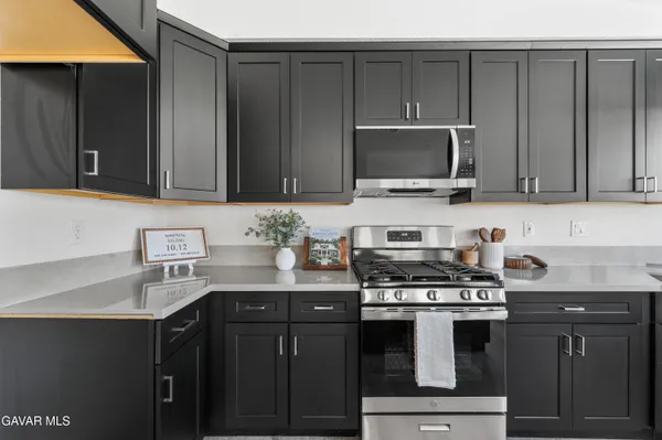 a kitchen with a sink stove and microwave