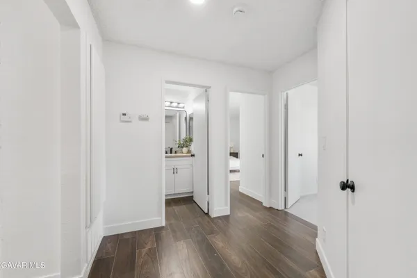a view of a room with wooden floor