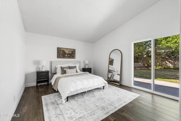 a bedroom with a bed and a large window