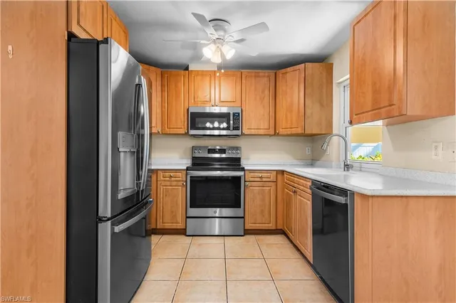 a kitchen with a refrigerator sink and cabinets