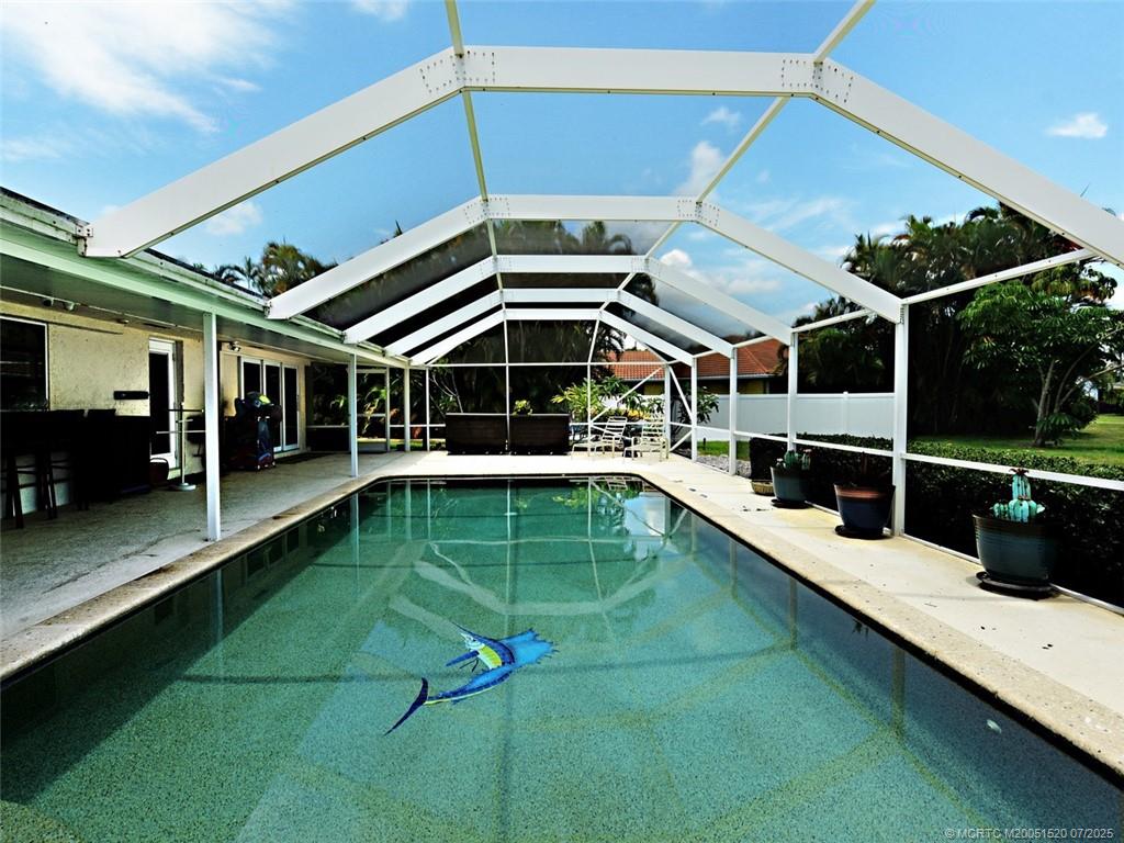 2645 Northwest S Shore Road Stuart, FL 34994 - Photo 11 of 51 a view of a backyard with a patio and a yard