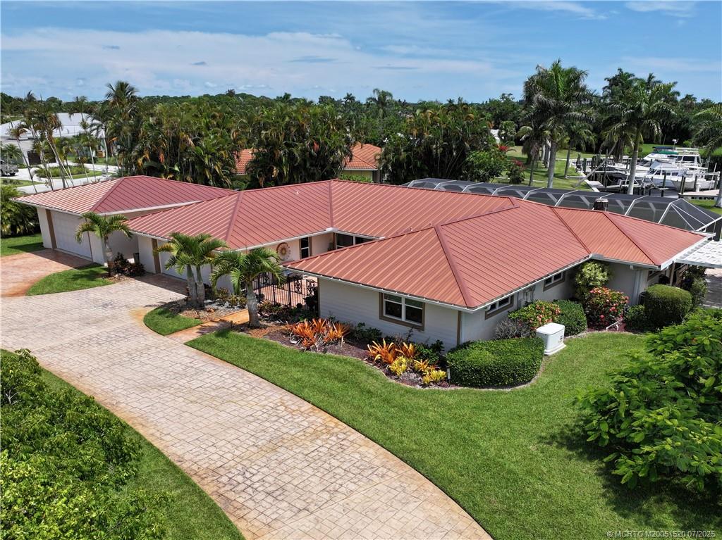 2645 Northwest S Shore Road Stuart, FL 34994 - Photo 3 of 51 an aerial view of a house with garden space and street view