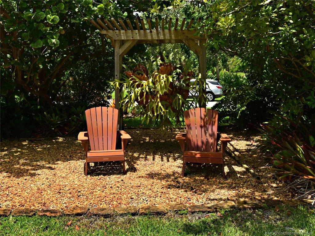 2645 Northwest S Shore Road Stuart, FL 34994 - Photo 47 of 51 a bench sitting in the middle of a yard