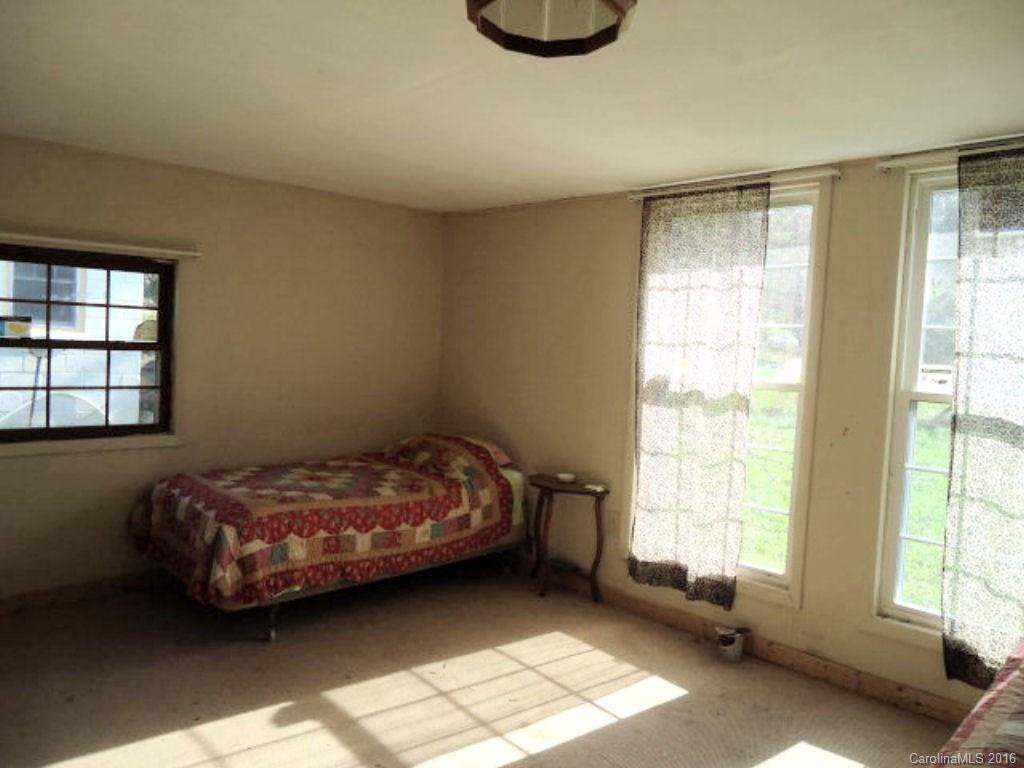 756 East Deep Creek Road Bryson City, NC 28713 - Photo 5 of 7 a bed sitting in a bedroom next to a window