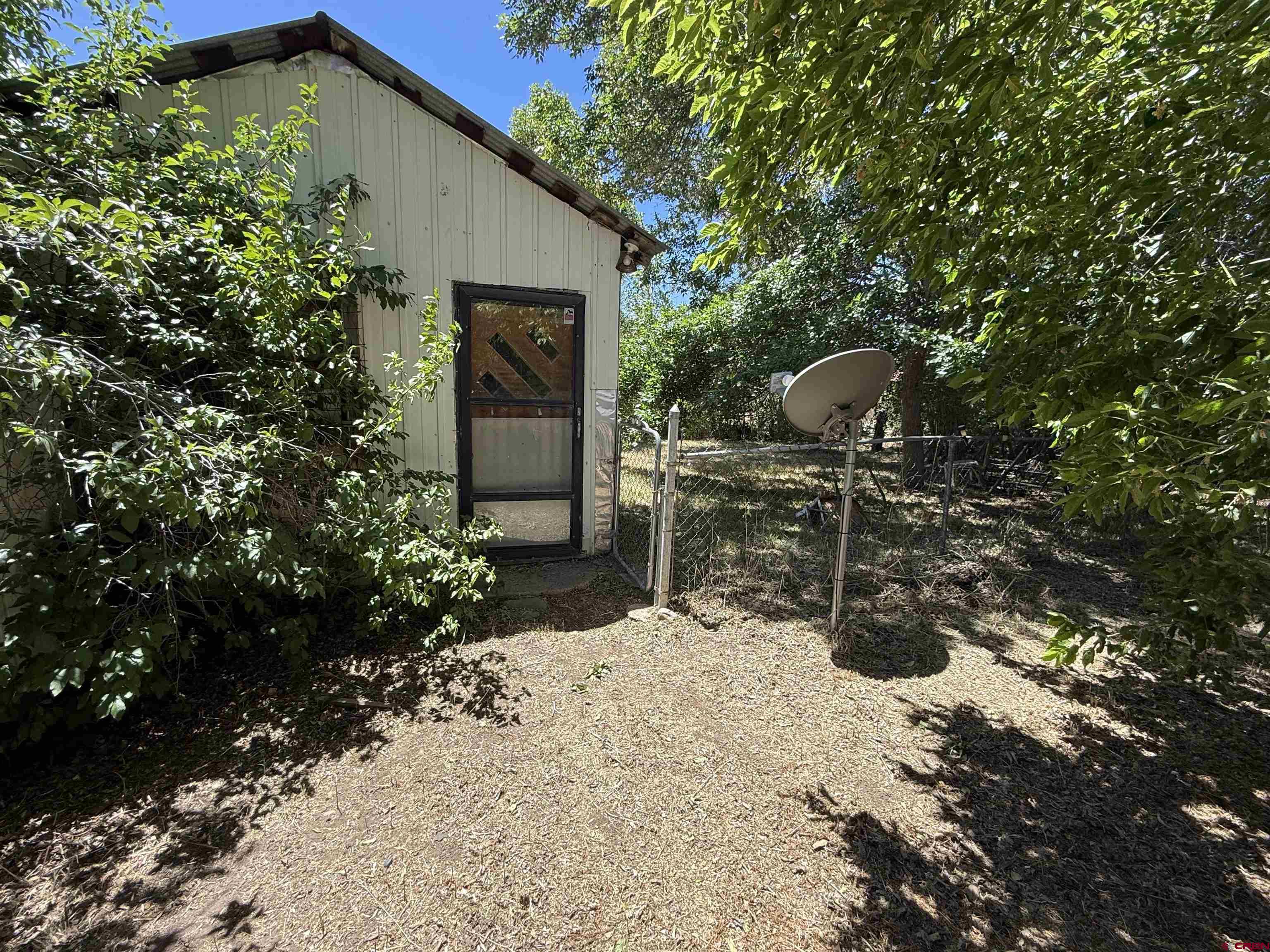 202 Riverside Avenue Dolores, CO 81323 - Photo 3 of 4 a front view of a house with a yard