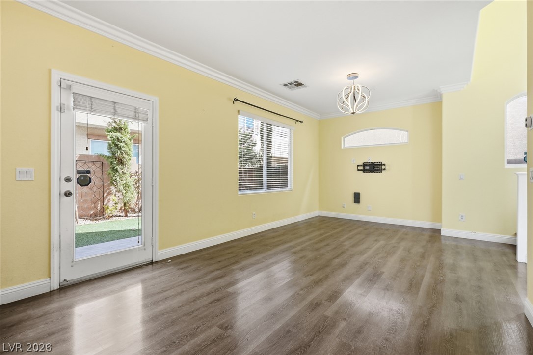 8932 Caledon Ridge Court Las Vegas, NV 89149 - Photo 16 of 39 Smooth wood-look flooring and crown molding define this versatile living space.