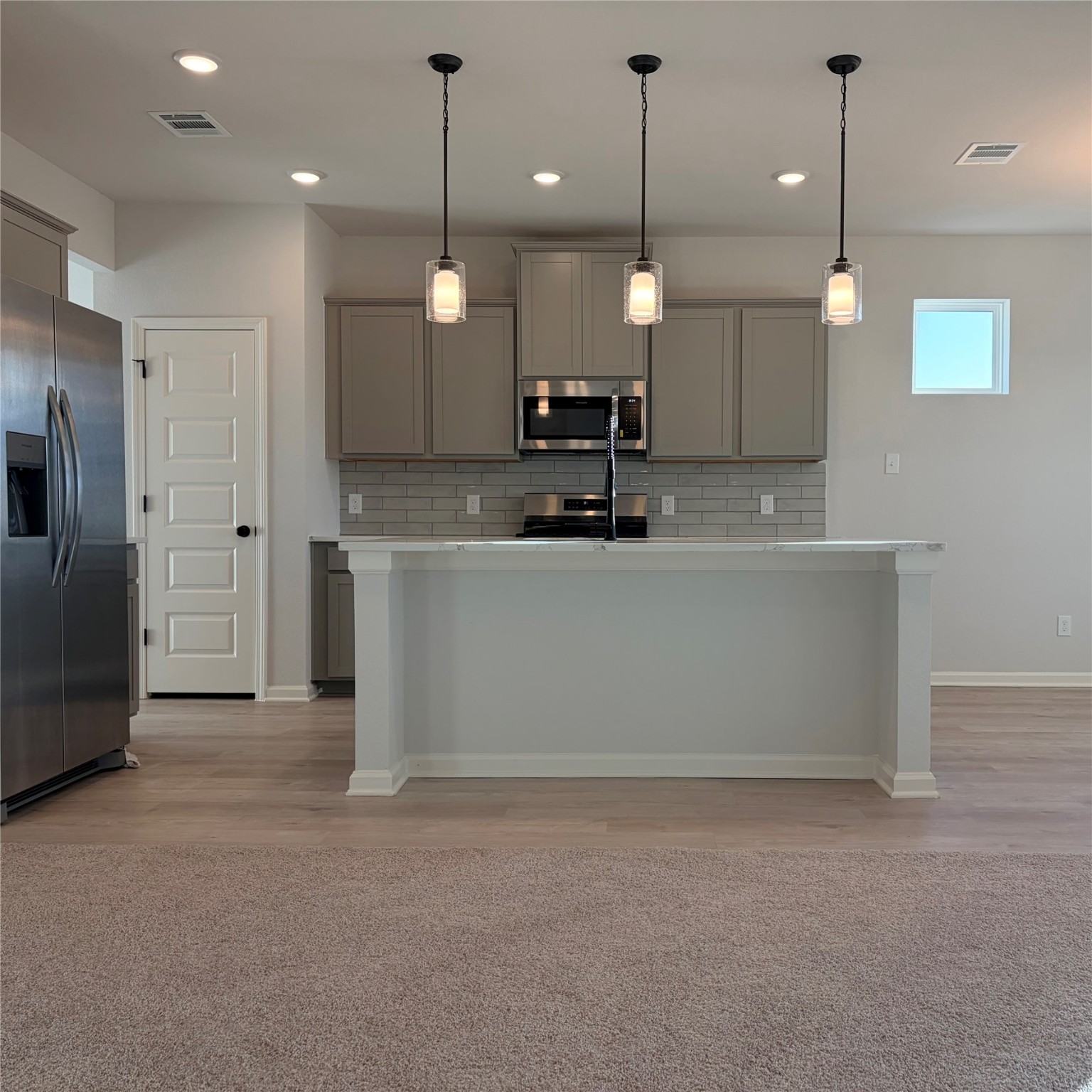 3418 Lago Norence Drive Manvel, TX 77578 - Photo 5 of 18 a view of a kitchen with a sink and refrigerator