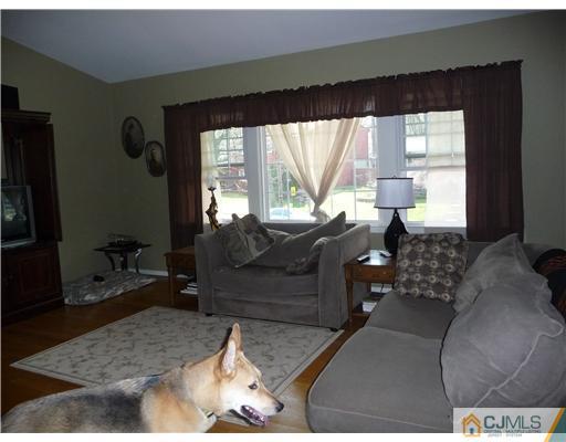 74 Harmon Road Edison, NJ 08837 - Photo 2 of 9 a living room with furniture and a large window
