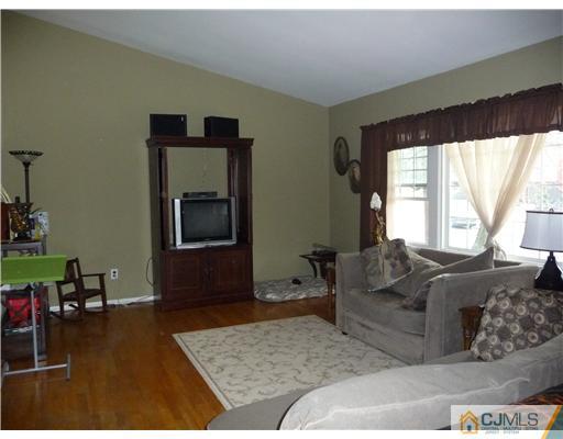 74 Harmon Road Edison, NJ 08837 - Photo 3 of 9 a living room with furniture and a rug