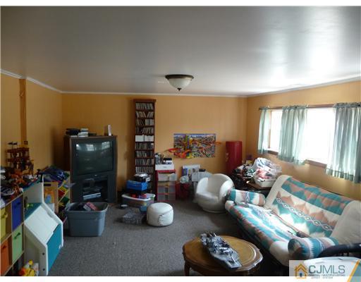 74 Harmon Road Edison, NJ 08837 - Photo 7 of 9 a living room with furniture and a window