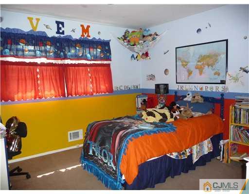 74 Harmon Road Edison, NJ 08837 - Photo 8 of 9 a bed room with a bed and a couch