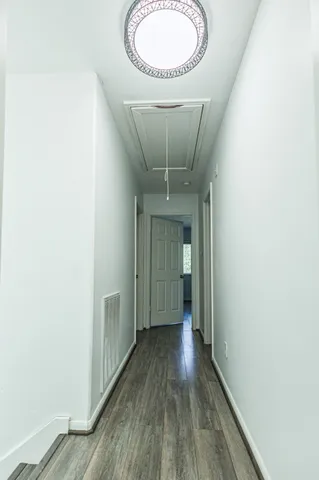 a view of a room with wooden floor