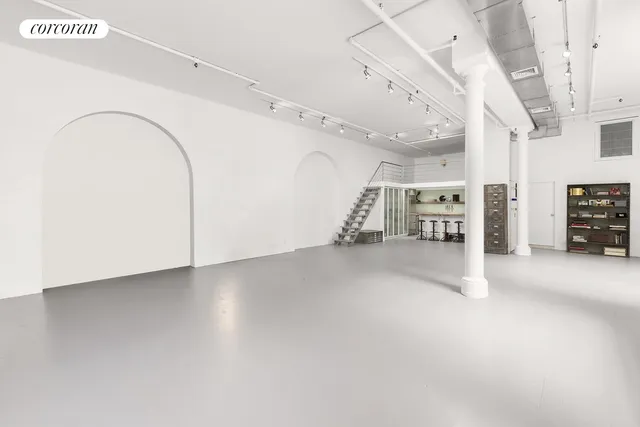 a kitchen with refrigerator and cabinets