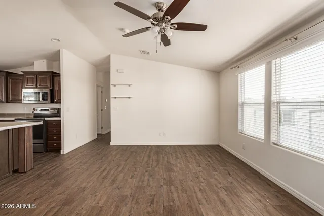 a view of a kitchen with a stove cabinets wooden floor and a window