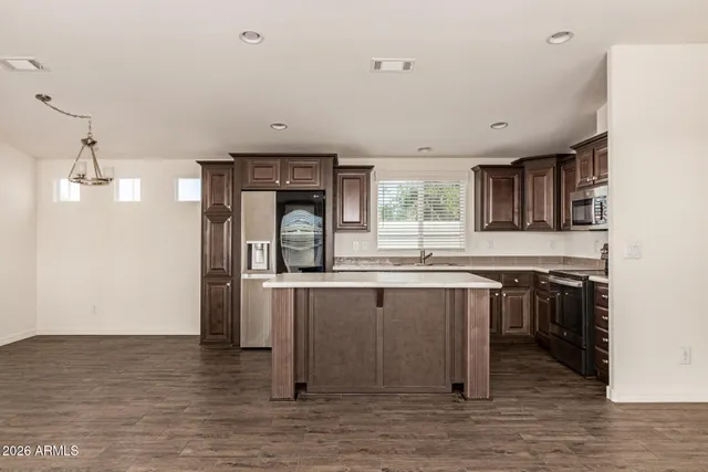 a kitchen with stainless steel appliances granite countertop a stove and a sink
