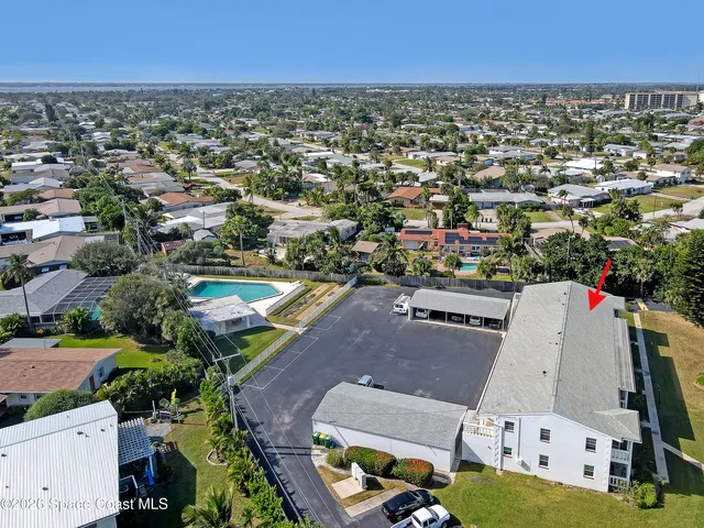 an aerial view of residential houses with outdoor space
