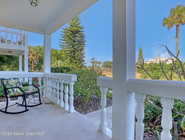 a view of a porch with furniture and garden