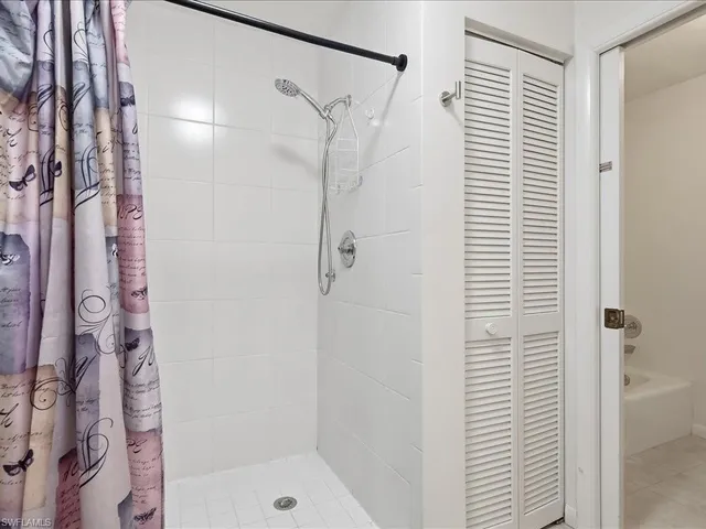 a bathroom with a shower and a glass door