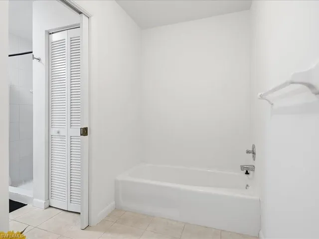 a bathroom with bathtub and shower
