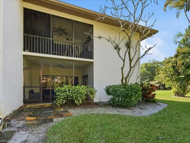 a view of a house with a yard and plants