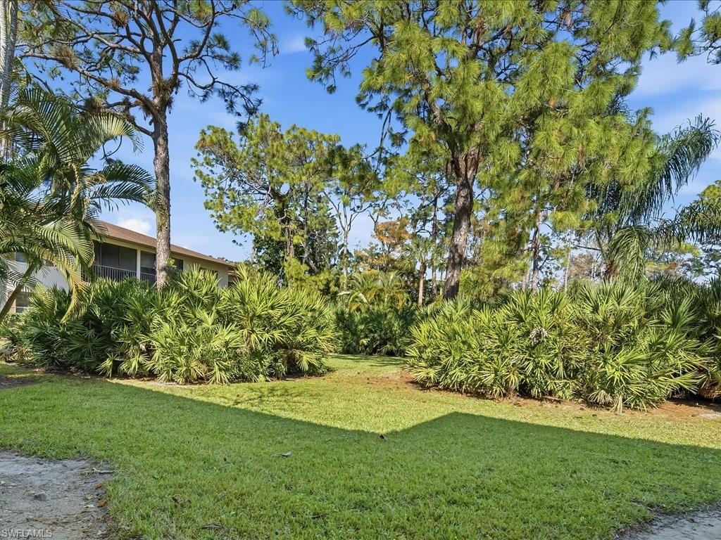 1833 Courtyard Way, Unit E105 Naples, FL 34112 - Photo 22 of 28 View of green lawn