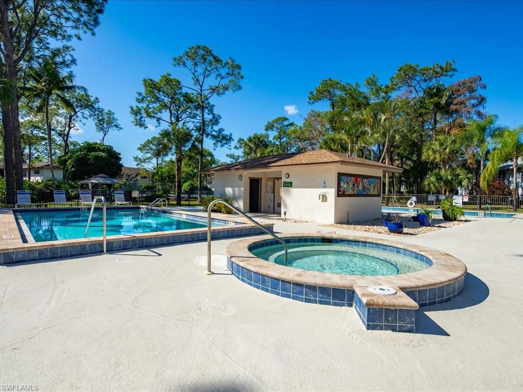 1833 Courtyard Way, Unit E105 Naples, FL 34112 - Photo 26 of 28 Community pool featuring a community hot tub and a patio