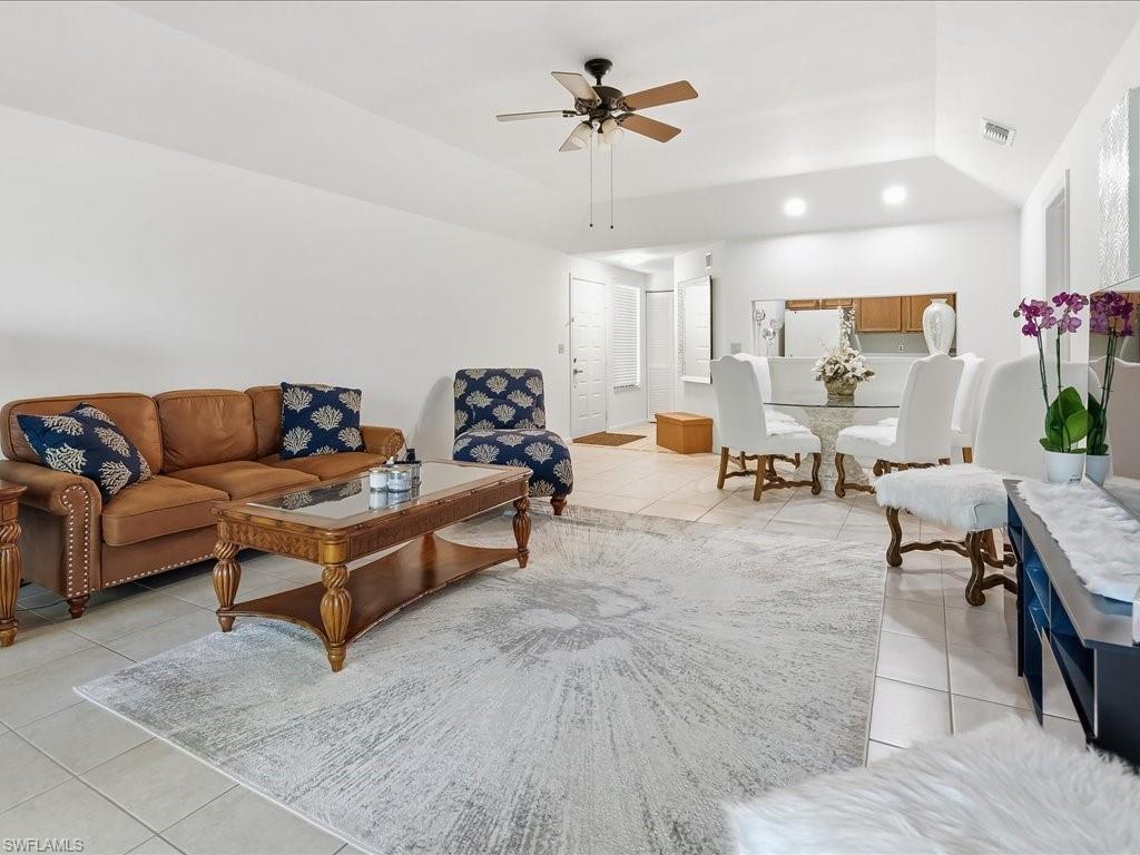 1833 Courtyard Way, Unit E105 Naples, FL 34112 - Photo 8 of 28 Living area featuring light tile patterned floors, lofted ceiling, recessed lighting, and ceiling fan