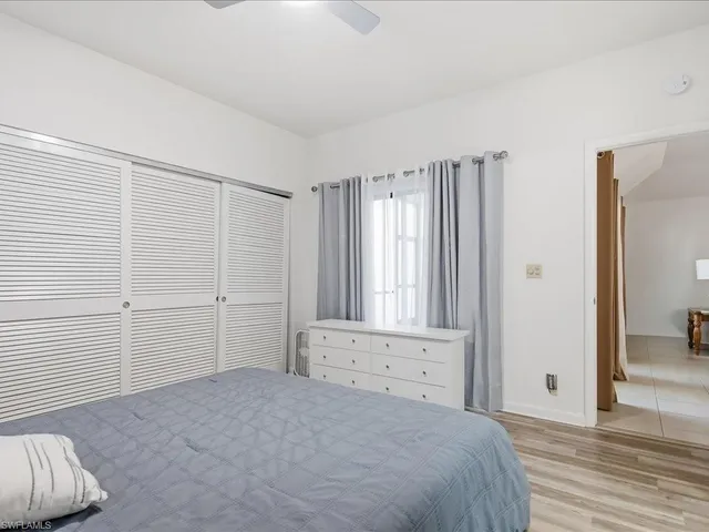 a bedroom with a bed and a mirror