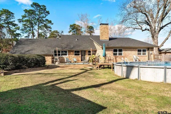 a view of house with outdoor space and swimming pool