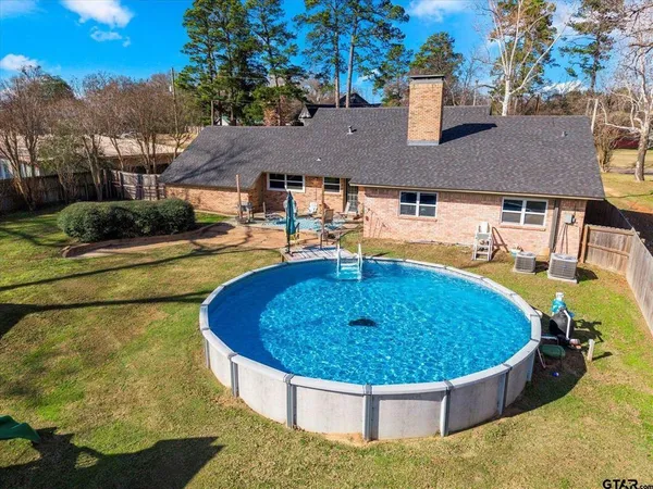 a view of a swimming pool with a patio