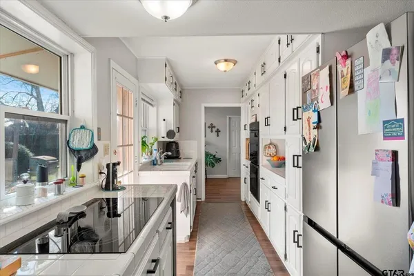 a kitchen with refrigerator and cabinets