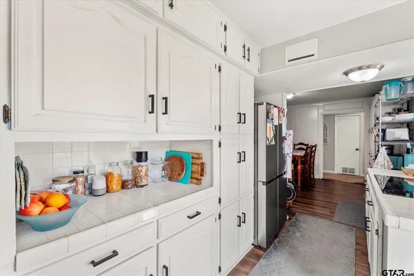 a hallway with white cabinets