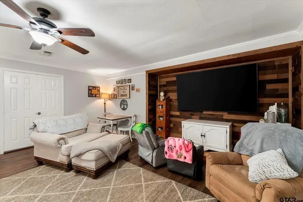 a living room with furniture and a flat screen tv